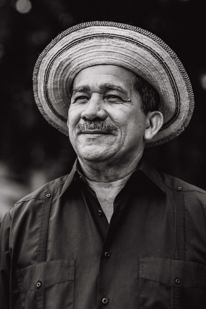 man wearing hat and collared shirt