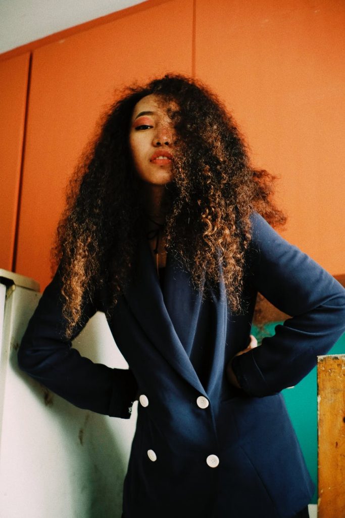 woman with curly hair wearing blue blazer