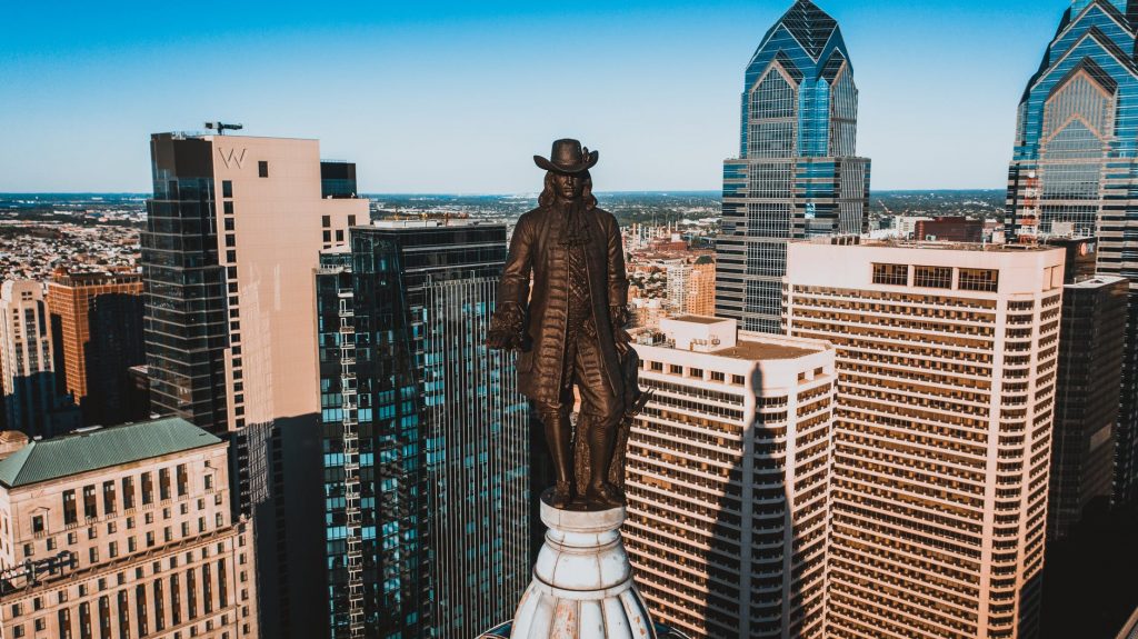 bronze statue of founder of city on top of building