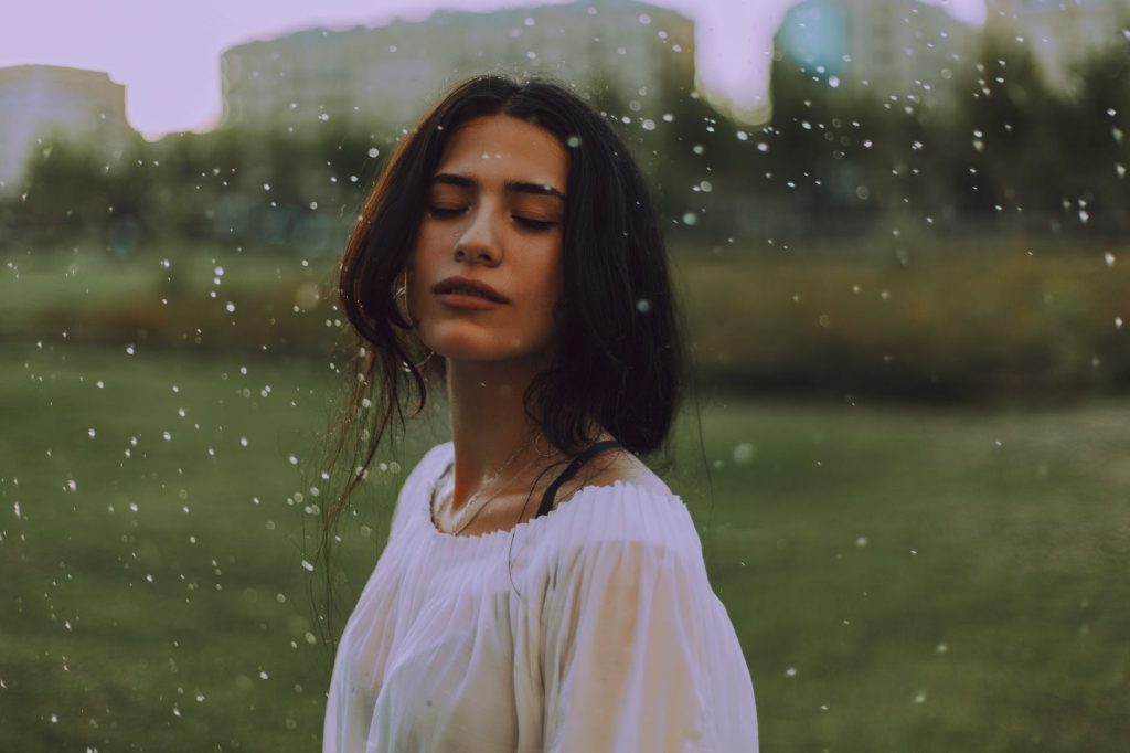 woman in white shirt with green background