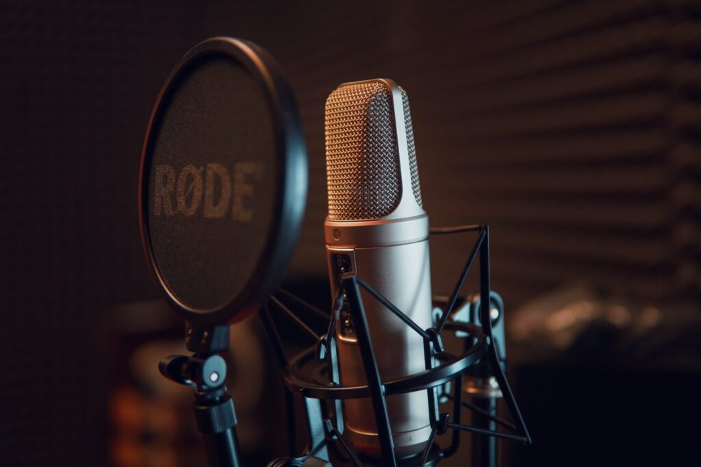 silver dynamic microphone on black microphone stand