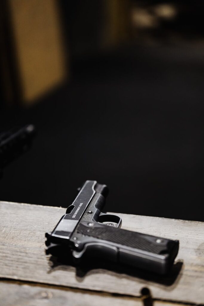 black semi automatic pistol on brown wooden table