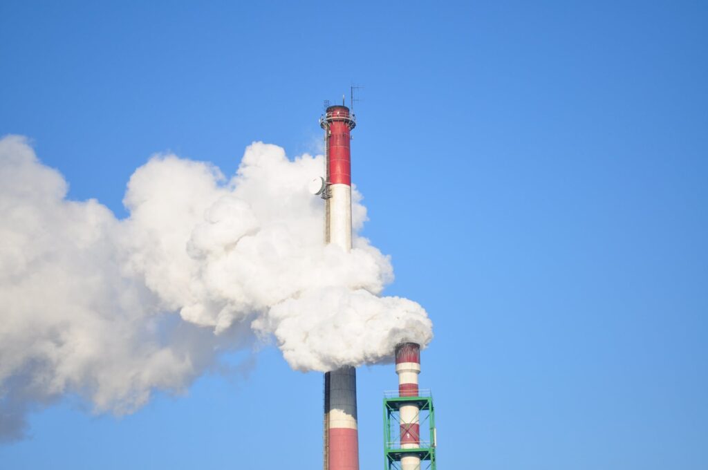 smoke stacks against blue sky