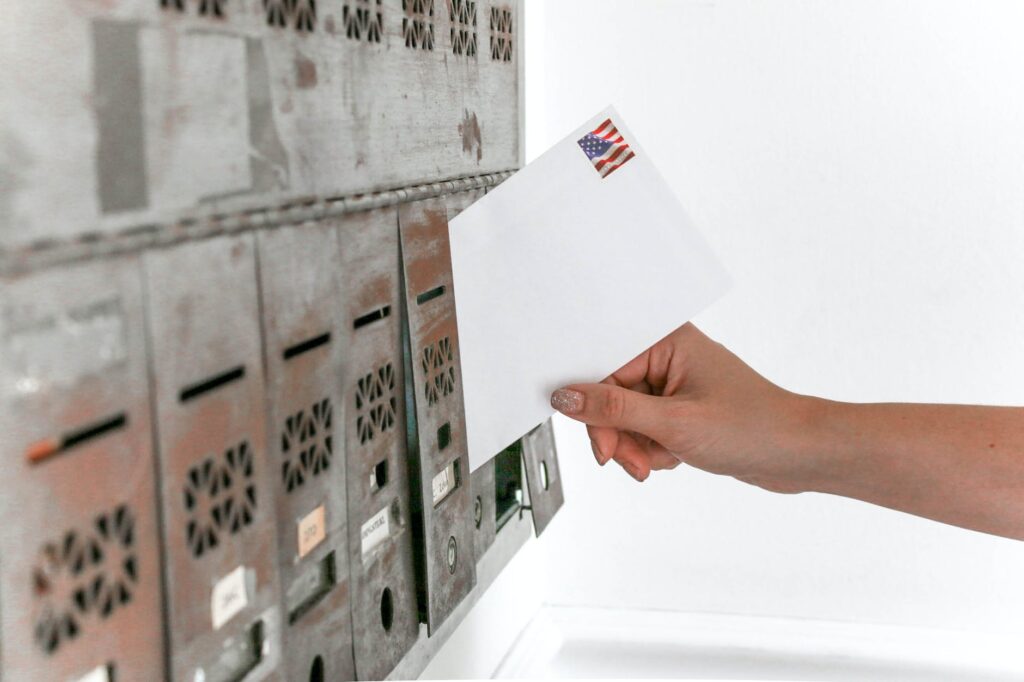 person holding white envelope