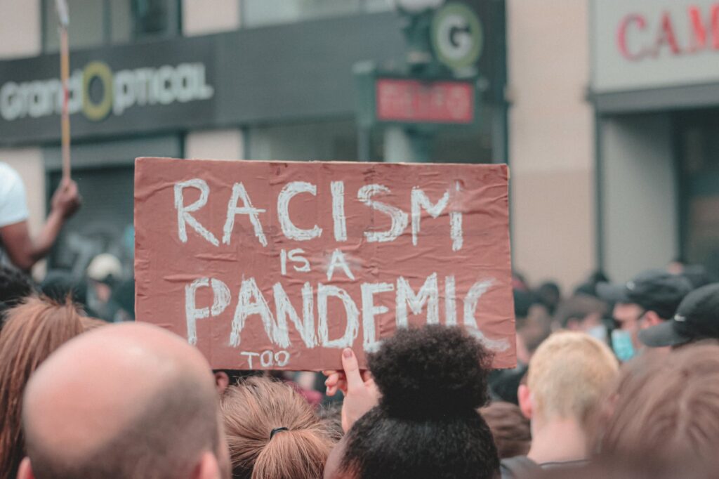 unrecognizable person with poster against police brutality